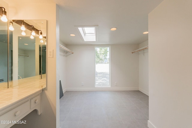 walk in closet featuring a skylight