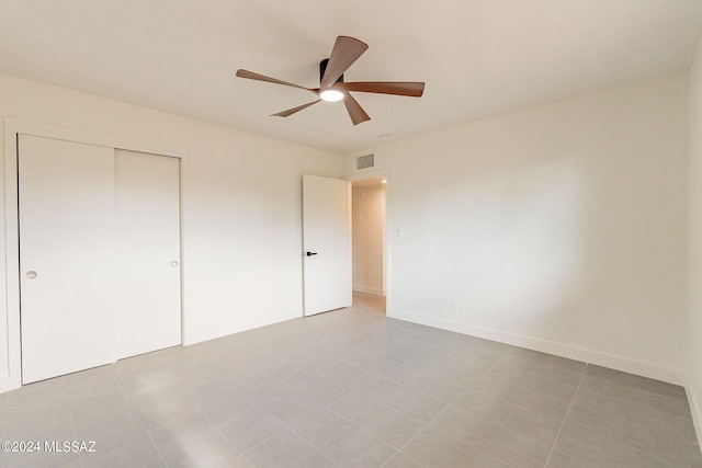 unfurnished bedroom with visible vents, baseboards, ceiling fan, and a closet