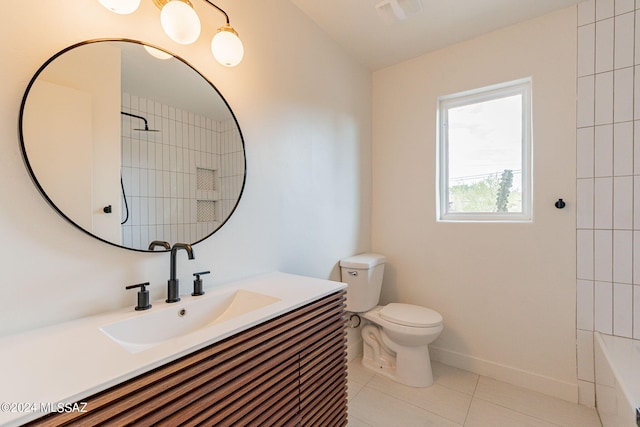 bathroom with toilet, vanity, baseboards, visible vents, and tile patterned floors