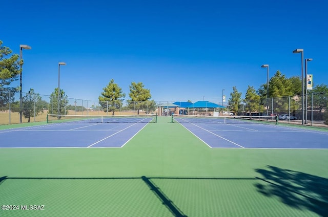 view of tennis court with fence and community basketball court