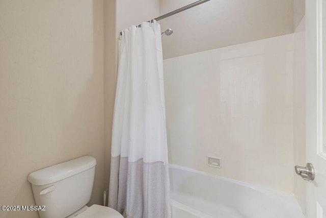 full bath featuring toilet and shower / bath combo with shower curtain