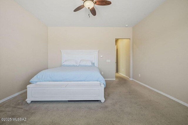 carpeted bedroom with baseboards and ceiling fan