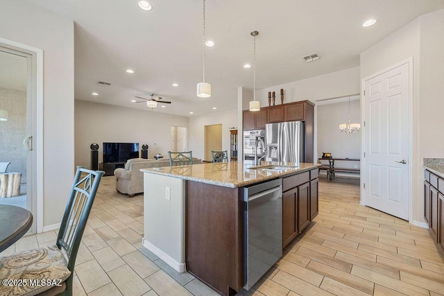 kitchen featuring visible vents, pendant lighting, a sink, stainless steel appliances, and recessed lighting