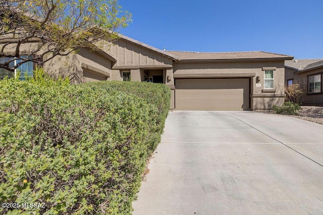single story home with a garage, board and batten siding, and driveway