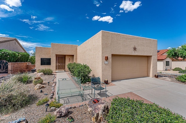 pueblo-style house with a garage