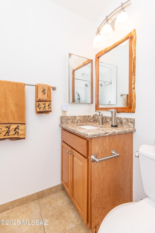 bathroom featuring vanity, toilet, and tile patterned flooring