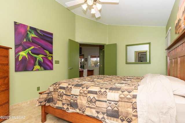 tiled bedroom featuring ceiling fan and vaulted ceiling