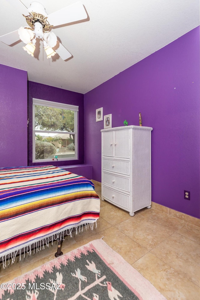 tiled bedroom with ceiling fan