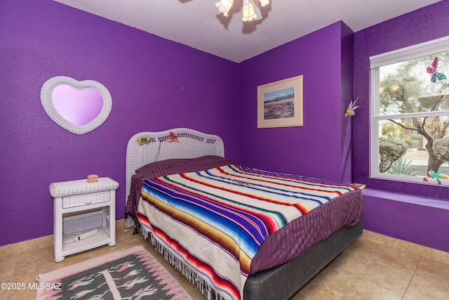 bedroom featuring ceiling fan and light tile patterned floors