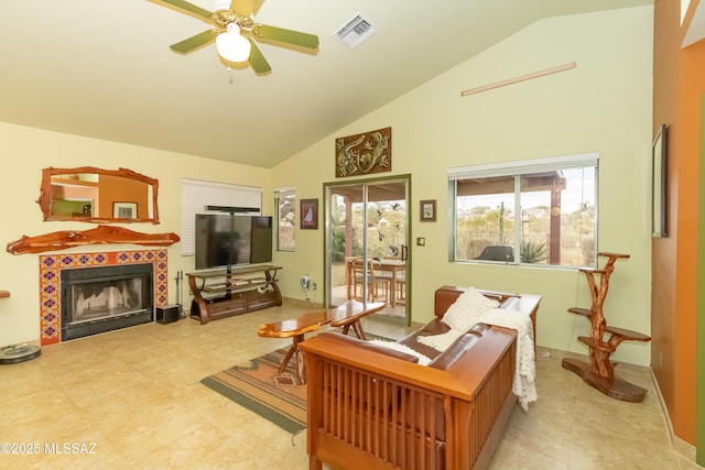 tiled living room featuring ceiling fan, high vaulted ceiling, and a fireplace