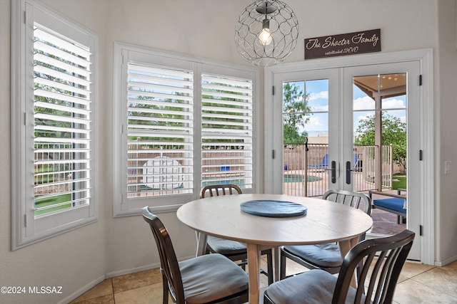 dining room with a healthy amount of sunlight, french doors, and light tile patterned floors