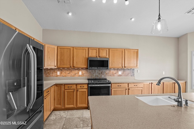 9797 E Holden Pl, Tucson, AZ 85748 - kitchen featuring stainless steel appliances, decorative backsplash, and light countertops