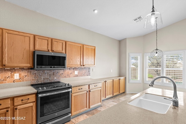 9797 E Holden Pl, Tucson, AZ 85748 - kitchen featuring stainless steel appliances, tasteful backsplash, hanging light fixtures, light countertops, and vaulted ceiling