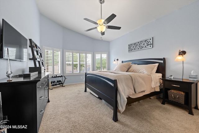 bedroom featuring light carpet, ceiling fan, and lofted ceiling