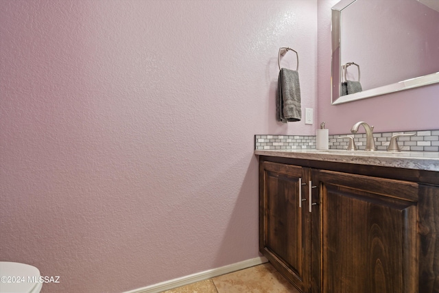 bathroom with tile patterned floors, vanity, and toilet