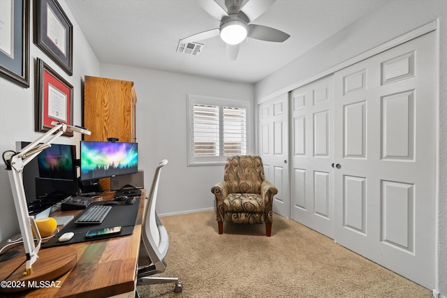 carpeted home office with ceiling fan