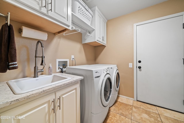 clothes washing area featuring cabinets, separate washer and dryer, light tile patterned floors, and sink