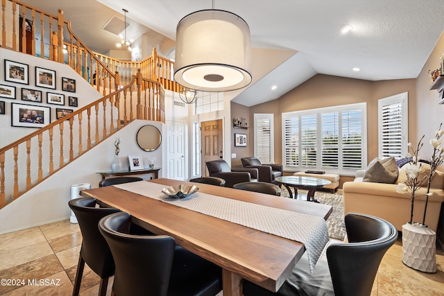 dining area featuring vaulted ceiling and a chandelier