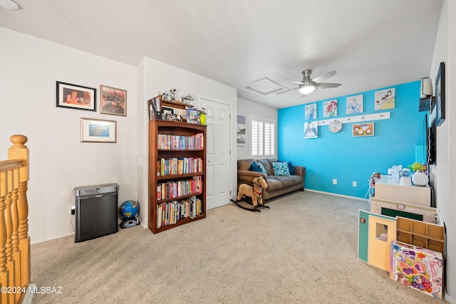 living area with ceiling fan and carpet flooring