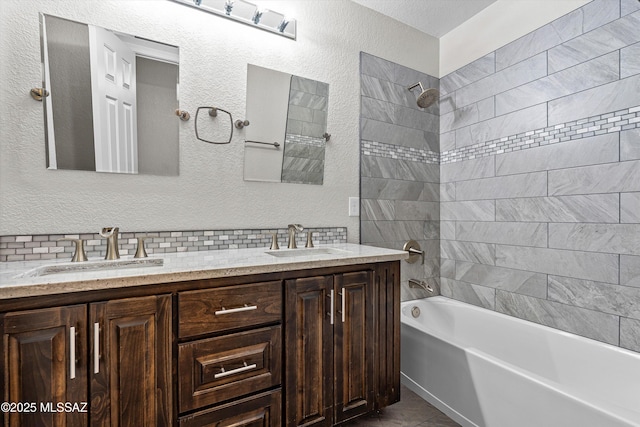 9797 E Holden Pl, Tucson, AZ 85748 - bathroom with double vanity, shower / tub combination, a textured wall, and tasteful backsplash