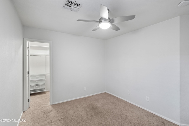 unfurnished room featuring ceiling fan and light colored carpet