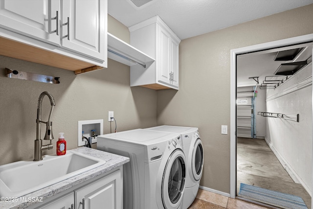 9797 E Holden Pl, Tucson, AZ 85748 - washroom with washer and clothes dryer and cabinet space