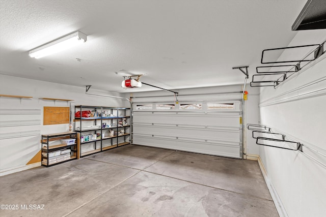 9797 E Holden Pl, Tucson, AZ 85748 - garage with a garage door opener and baseboards