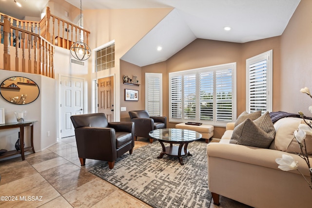 living room featuring vaulted ceiling and light tile patterned floors