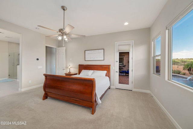 carpeted bedroom featuring ceiling fan and ensuite bathroom