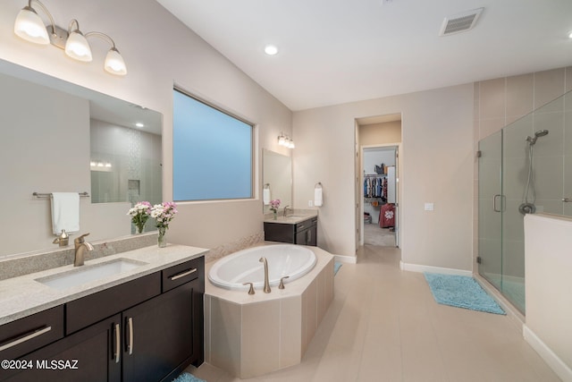 bathroom with vanity and separate shower and tub