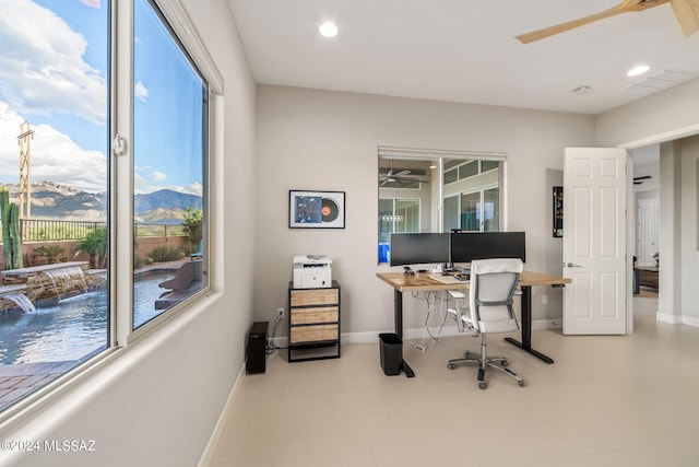 home office with ceiling fan and a mountain view