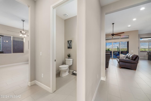 hall featuring light tile patterned floors