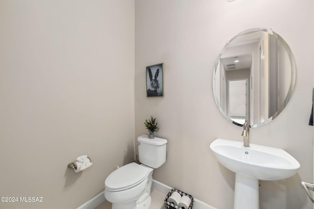 bathroom with tile patterned flooring, sink, and toilet