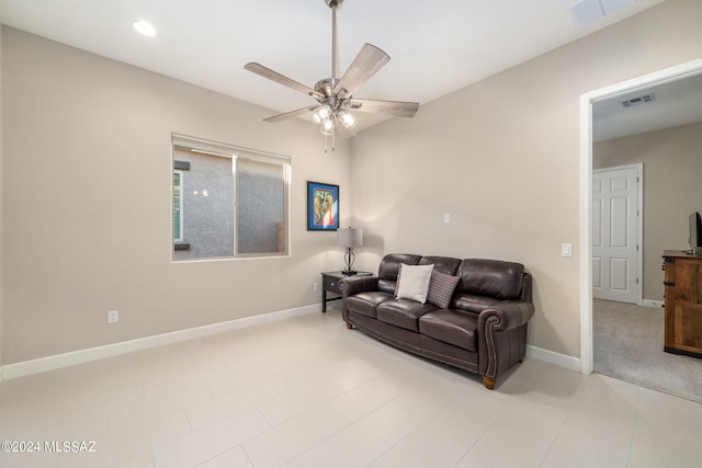 living room with ceiling fan and tile patterned floors