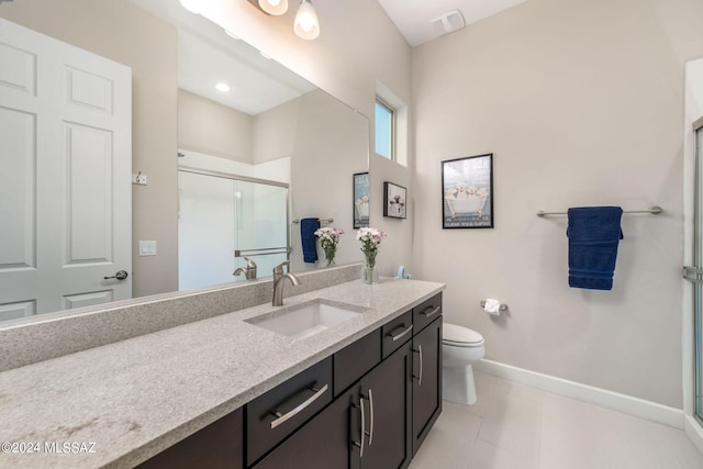 bathroom featuring vanity, toilet, tile patterned floors, and a shower with shower door