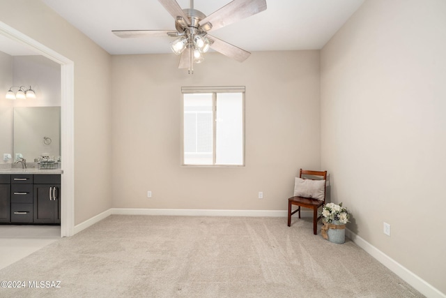 unfurnished room featuring indoor wet bar, ceiling fan, and light colored carpet