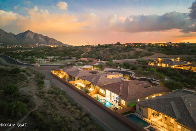 aerial view at dusk featuring a mountain view