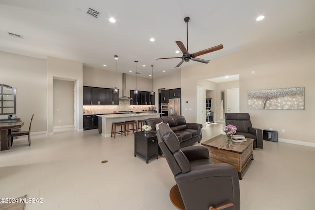 tiled living room with sink and ceiling fan