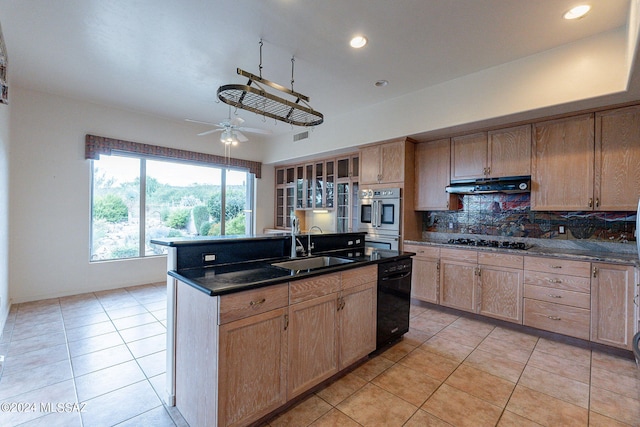 kitchen with ceiling fan, light tile patterned floors, sink, a kitchen island with sink, and black appliances