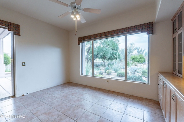 unfurnished room featuring ceiling fan and light tile patterned floors