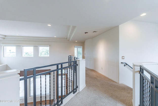 hallway with light colored carpet