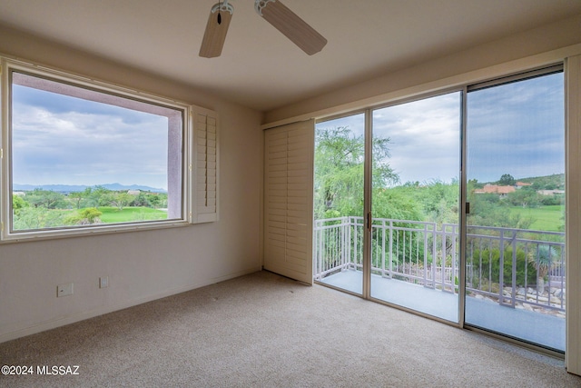 empty room with carpet floors and ceiling fan