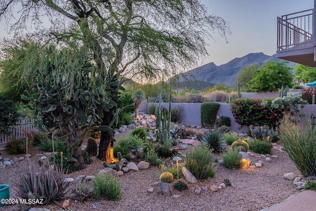 yard at dusk featuring a mountain view