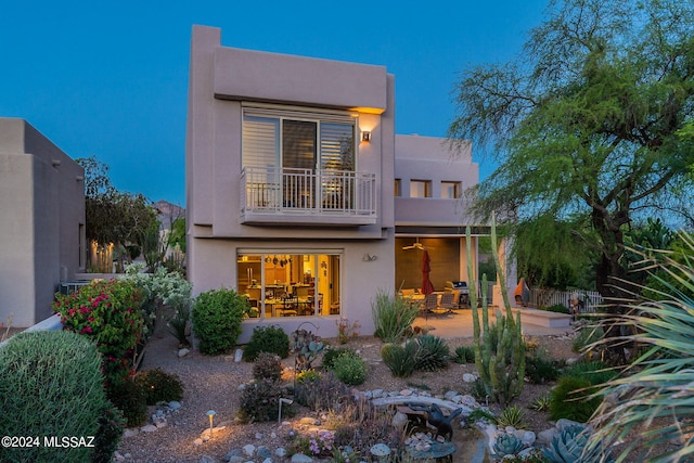 view of front of house featuring a balcony and a patio area