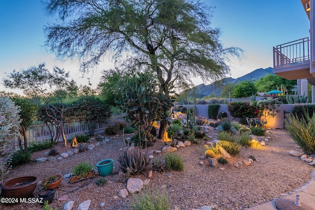 yard at dusk featuring a mountain view