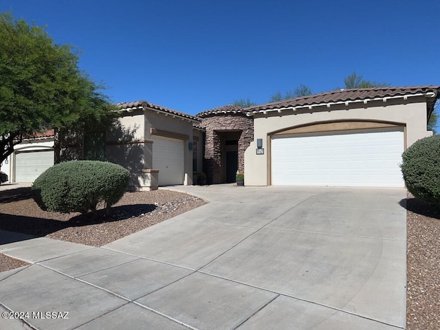 mediterranean / spanish-style home with a garage