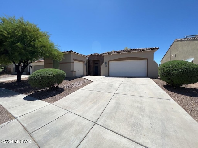 mediterranean / spanish-style home with a garage