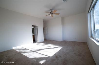 carpeted empty room featuring ceiling fan