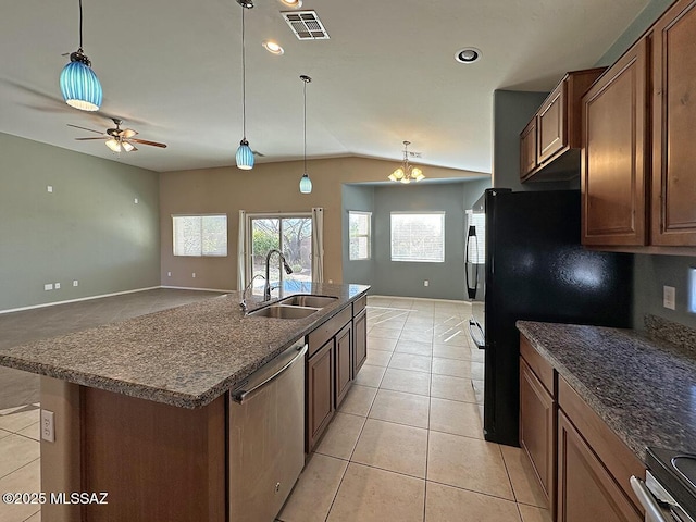 kitchen with stainless steel appliances, a sink, visible vents, brown cabinets, and a center island with sink