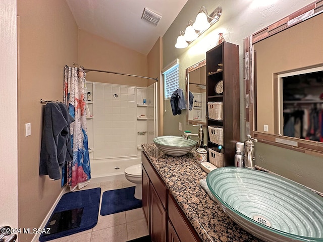 bathroom featuring a shower with shower curtain, tile patterned flooring, toilet, and vanity